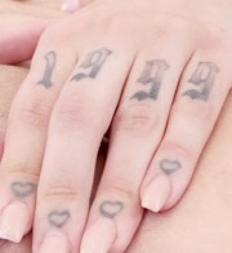 numbers (1999) and hearts on fingers of left hand