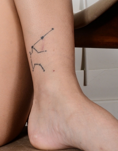 Lines tattoo above her left ankle